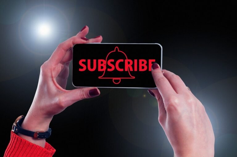 Hands holding a phone with red “SUBSCRIBE” text and bell icon - call to subscribe to MaLa Accounts newsletter